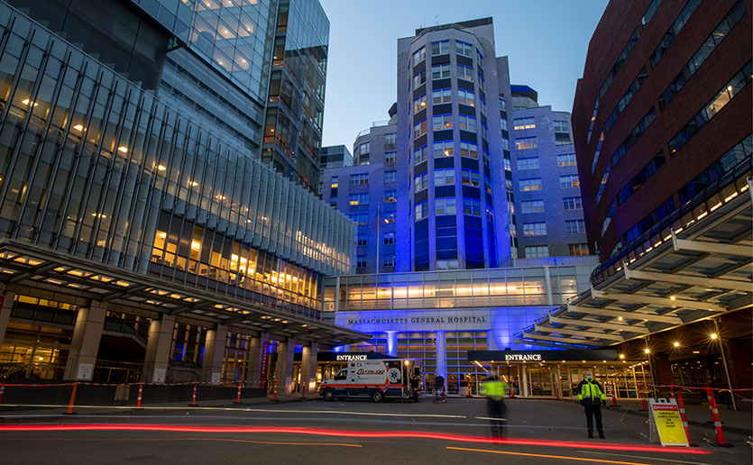MGH building lit up in blue