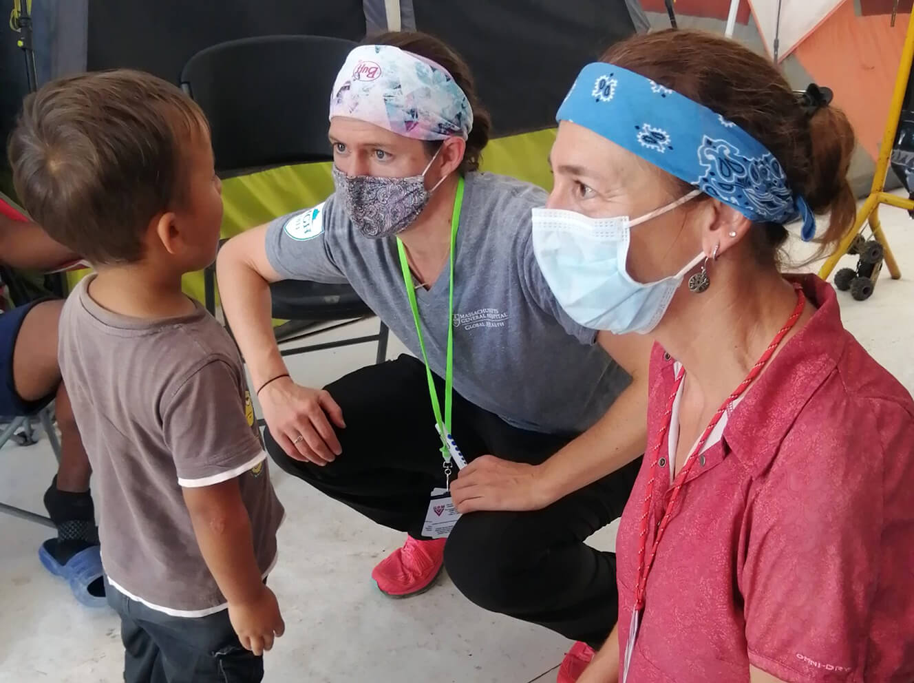 Lindsay Martin, NP, director of Global Disaster Response and Humanitarian Action, and Mary Sebert, RN, MPH, director of Global Nursing, interview a child at a migrant clinic in Matamoros, Mexico.