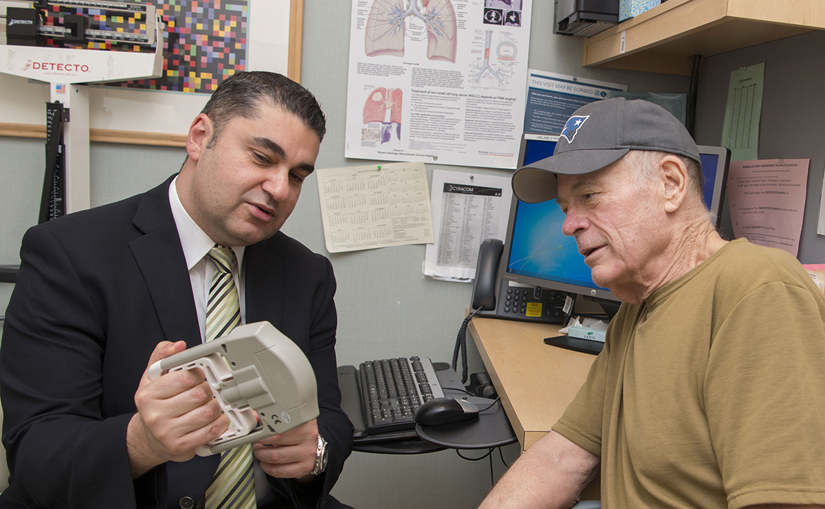 Motaz Qadan, MD, PhD, shown working with Navy veteran Robert Borcher in January 2020 to improve fitness and diet before surgery.