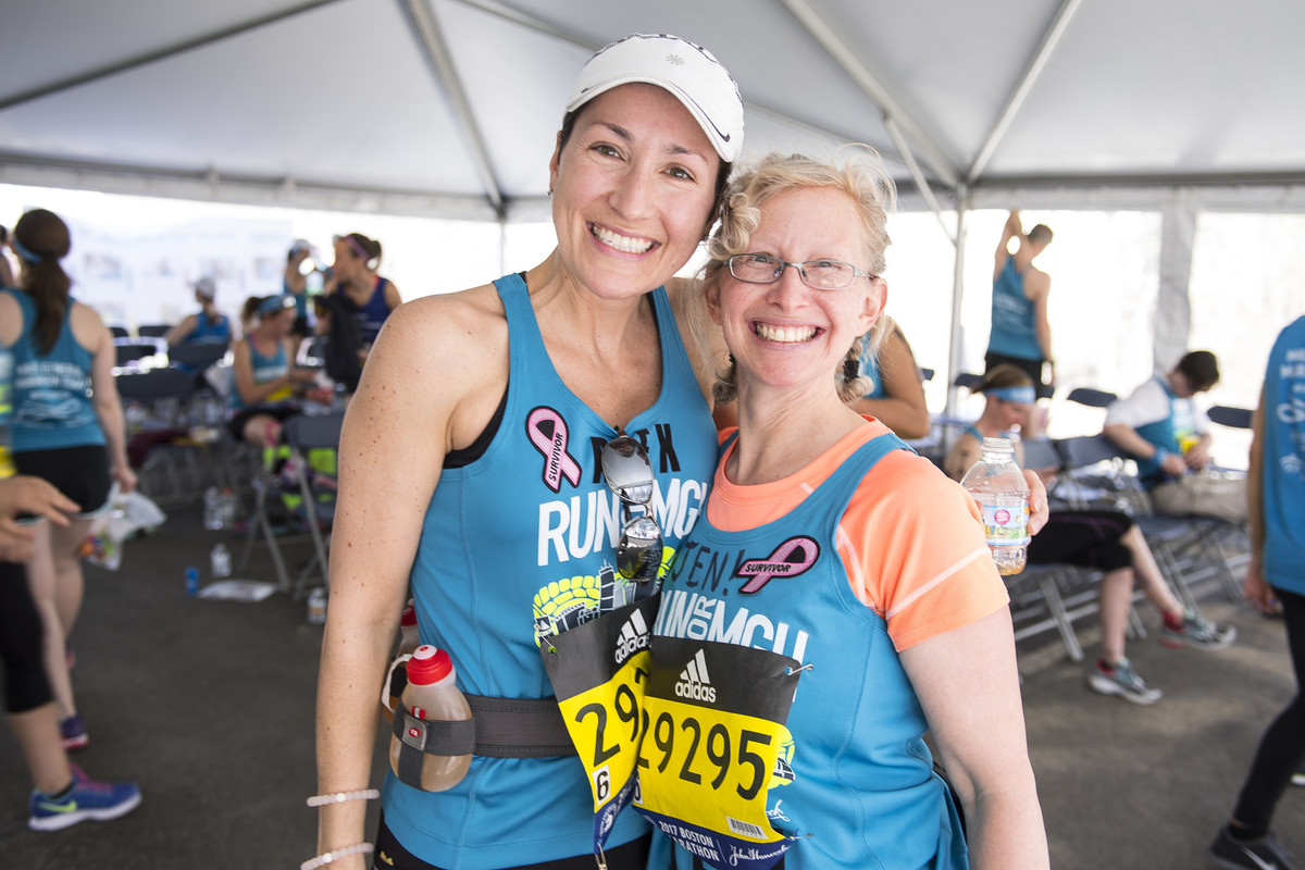 Marathon runners posing and smiling