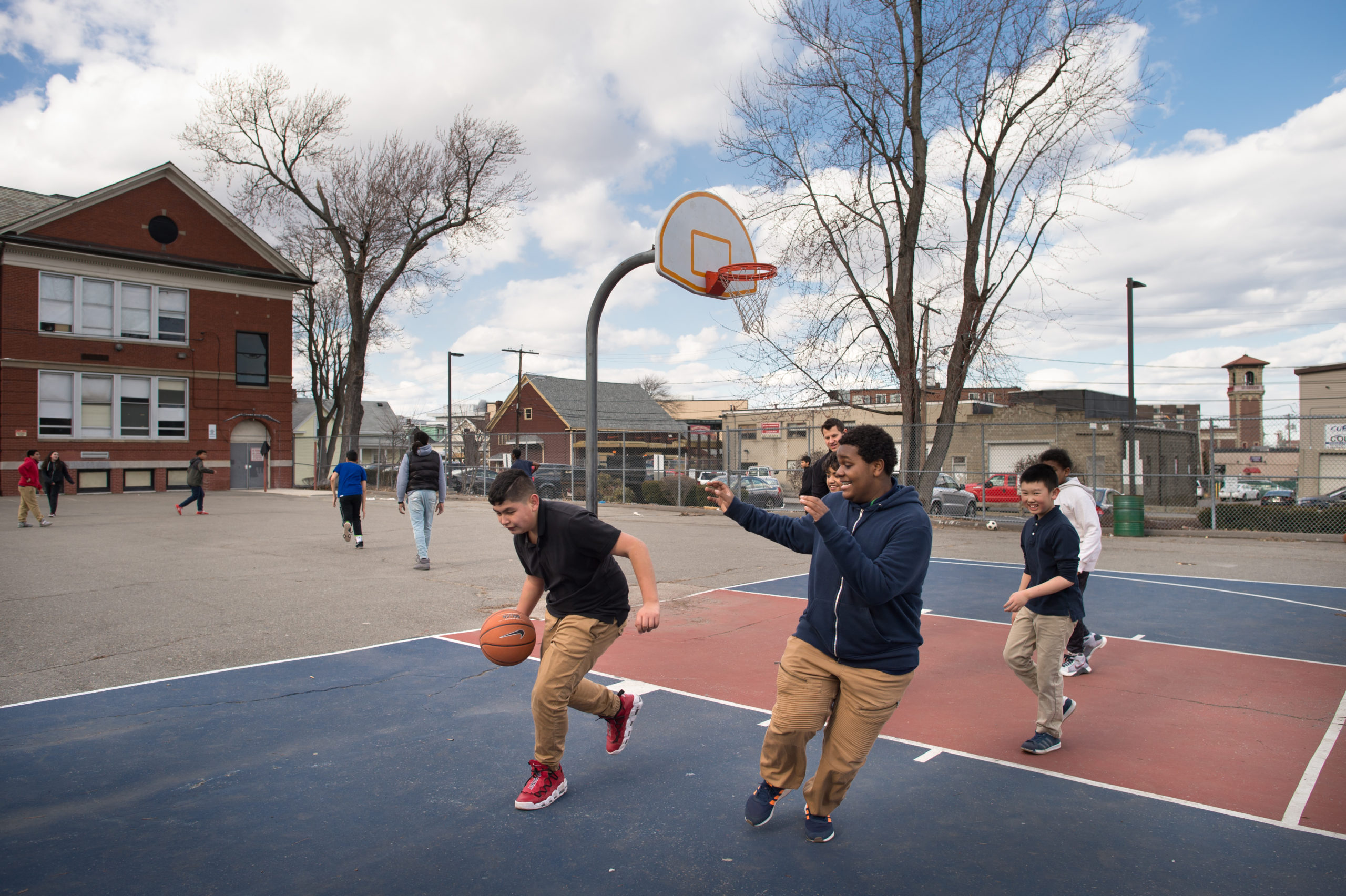 Afterschool youth group playing basketball in Revere, MA