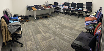 A room filled with clothes donations for program participants seeking workplace-appropriate attire.